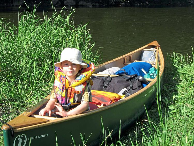 Ein junger Bub in einem Kanu.