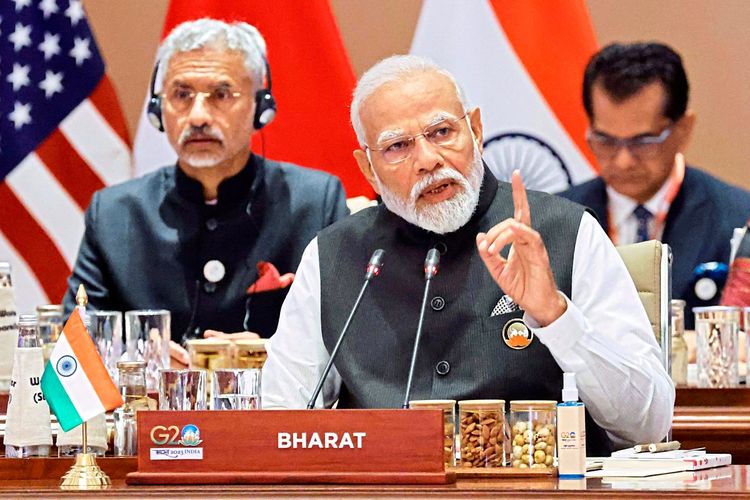 Indiens Premier Narendra Modi ist zu sehen. Auf dem Schild vor ihm steht 