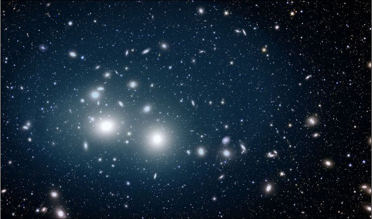 Ein Bild des Himmels mit zahllosen Galaxien und einem schwachen Lichtschleier im Zentrum.