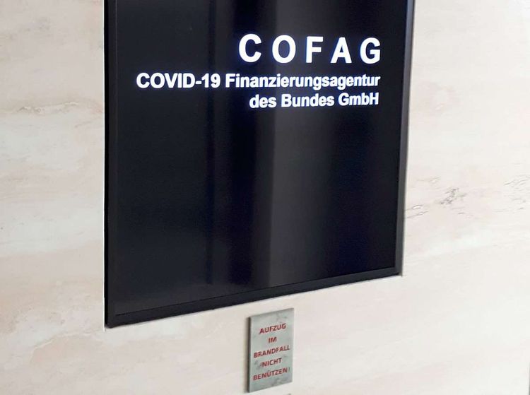 Ein Computerbildschirm mit dem Logo der Corona-Finanzierungsagentur Cofag vor einer Präsentation.