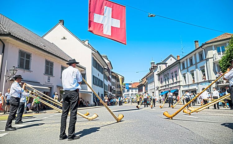 Einige Alphornbläser spielen das Schweizer Traditionsinstrument.