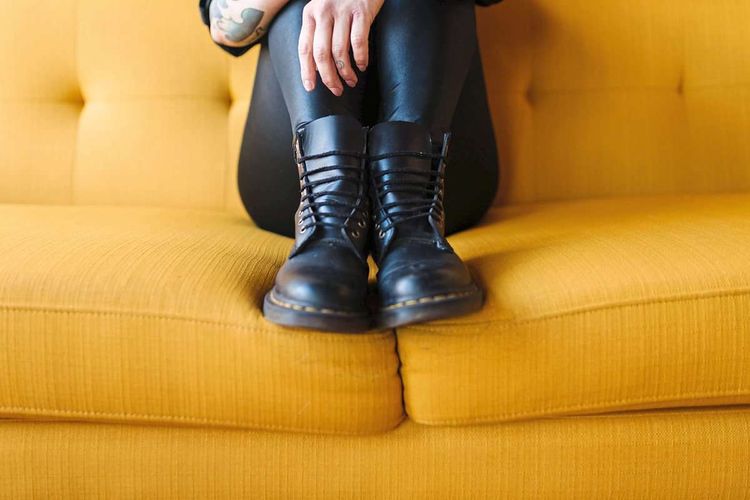 Creative Highlights Symbolbilder Up close of black boots side by side pulled up onto yellow couch Portland, Oregon, United States, Hausschuhe, Pantoffel, Wohnung