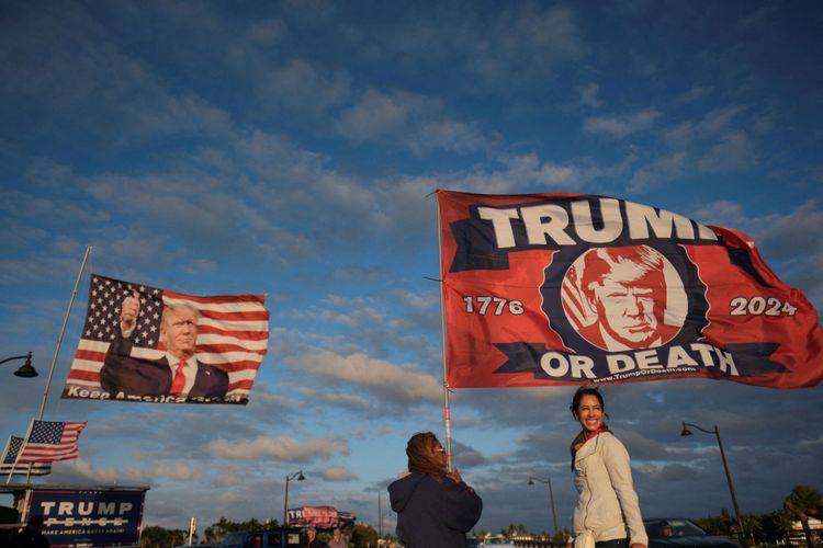 Zwei weibliche Trump-Fans mit einer Fahne. Auf dieser steht geschrieben: 