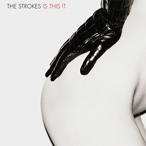 Schwarz-weißes Albumcover. Ein Teil eines nackten menschlichen Rückens ist zu sehen, mit einer schwarzen, glänzenden Handschuh tragenden Hand, die darauf ruht. Oben steht in Großbuchstaben „THE STROKES IS THIS IT“ mit „IS THIS IT“ in Rot hervorgehoben.