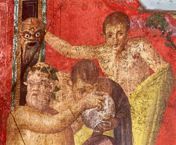 Ein Fresko mit drei Personen, einer hält dem anderen einen Krug hin, ein junger Mann im Hintergrund hält eine Maske mit verzerrtem Gesicht.