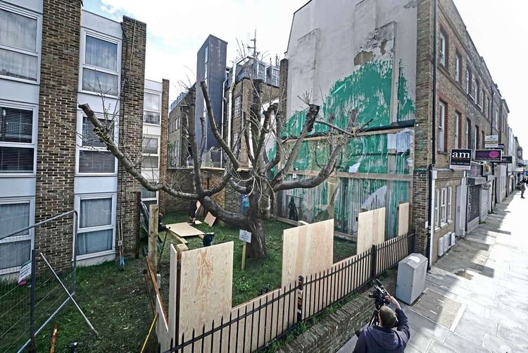 Um sowohl Kunstwerk als auch die Anrainer des Gebäudes zu schützen, umzäunt nun eine Absperrung das neu aufgetauchte Banksy-Bild.