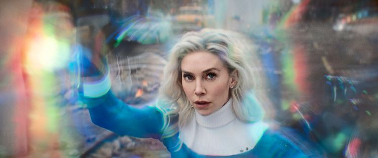 Vanessa Kirby als Superheldin im blauen Anzug vor verschwommener Kulisse.