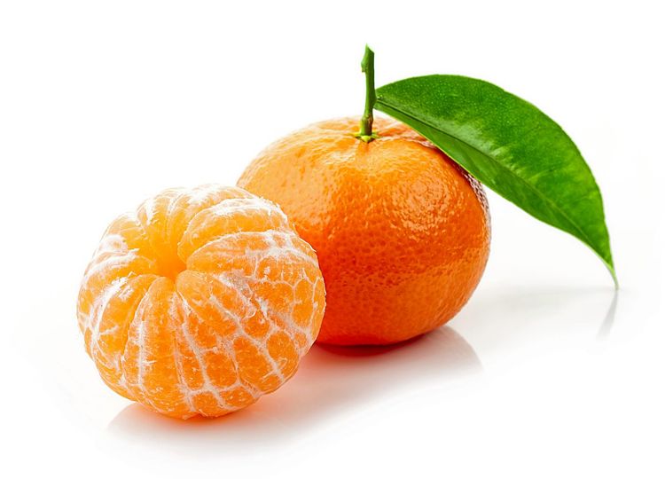Eine Mandarine mit Blatt und eine geschälte Mandarine