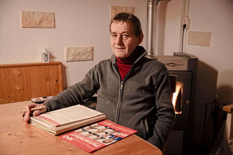Erwin Kasper sitzt an einem Tisch vor SPÖ-Infomaterial