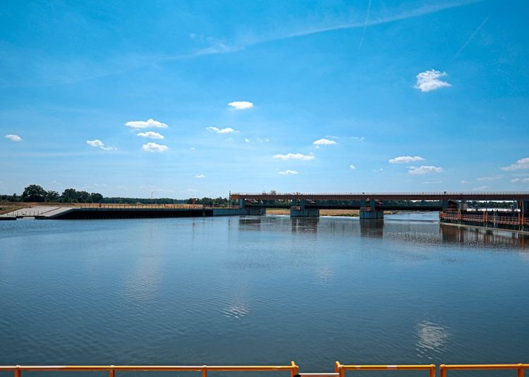 Dieses Symbolbild stammt von der Oder in Wrocław. Es zeigt strahlend blaues Wasser. Rechts im Bild ist auch eine Brücke zu sehen.