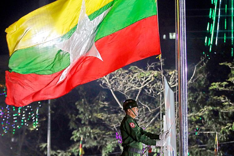Ein Soldat hisst die Flagge von Myanmar