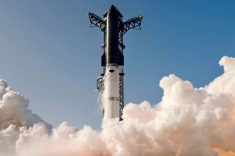 Eine Rakete (Starship) wird von einer Startrampe aus gestartet und ist von dichten Rauchwolken umgeben. Der Himmel ist klar und blau.