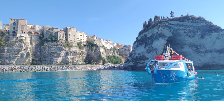 Boot im Meer vor italienischer Stadt