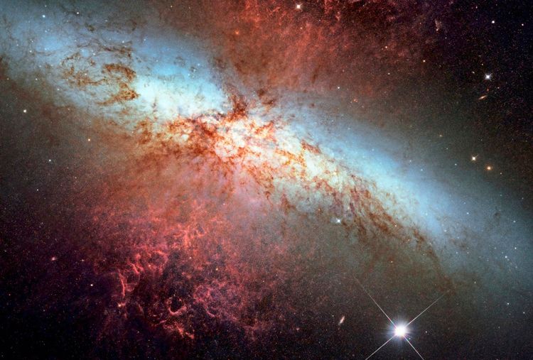 Ein beeindruckendes Hubble-Bild zeigt die Galaxie M82 mit der Supernova SN 2014J, einer Typ-Ia-Supernova. Die Galaxie ist etwa 11,5 Millionen Lichtjahre von der Erde entfernt. Das Bild, aufgenommen am 31. Januar 2014, zeigt die Supernova kurz vor ihrer maximalen Helligkeit. Im Vordergrund erstrahlen Gas- und Staubwolken in rötlichen und bläulichen Farben. Die Daten helfen Astronomen, Entfernungen zu Typ-Ia-Supernovae zu messen und mehr über die Sterne zu erfahren, die an der Explosion beteiligt waren.